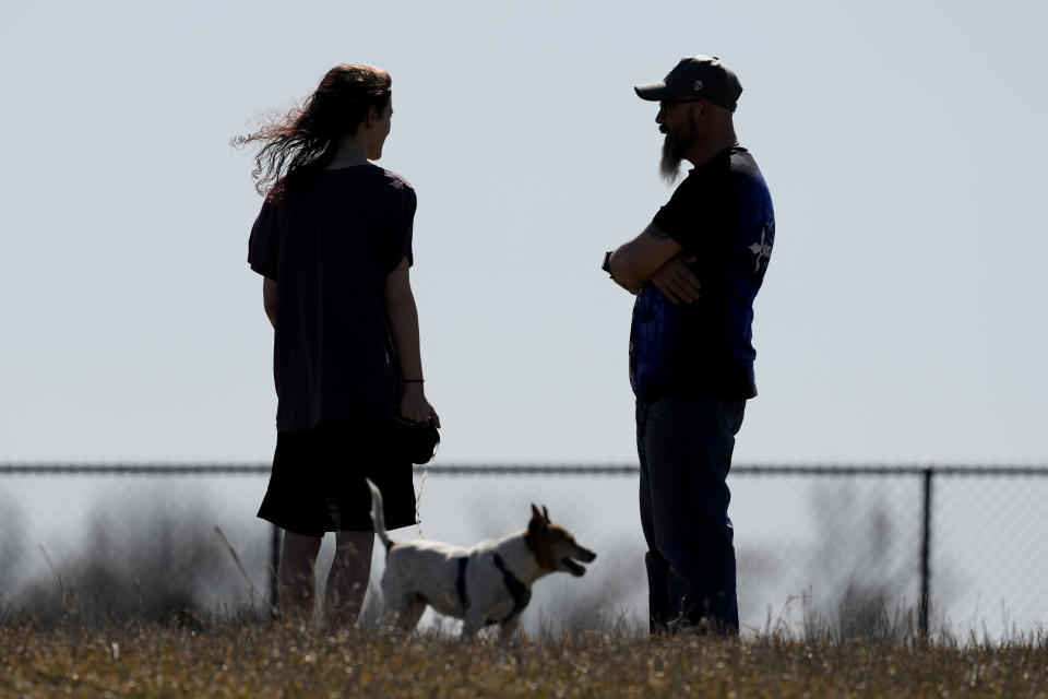 Dusty Farr talks with his transgender daughter at a park near Smithville, Mo., Sunday, Feb. 25, 2024. Farr is suing the Platt County School District after his daughter was suspended for using the girl's bathroom at the Missouri high school she attended. (AP Photo/Charlie Riedel)