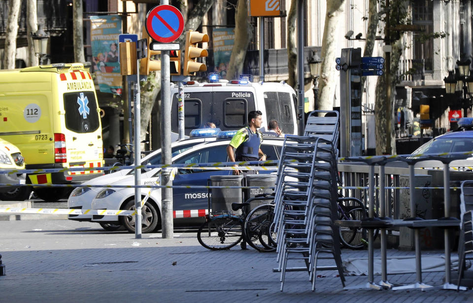 <p>Mossos d’Esquadra Police officers and emergency service workers set up a security perimeter near the site where a van crashes into pedestrians in Las Ramblas, downtown Barcelona, northeaster Spain, August 17, 2017. (Andreu Dalmau/EFE via ZUMA Press) </p>