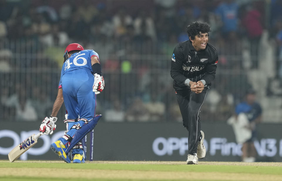 New Zealand's Rachin Ravindra celebrates a catch resulting in the dismissal of Afghanistan's Rahmat Shah during the ICC Cricket World Cup match between Afghanistan and New Zealand in Chennai, India, Wednesday, Oct. 18, 2023. (AP Photo/Eranga Jayawardena)