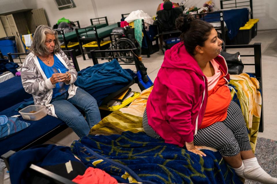 Nancy Gardner (left) and Diana Carreon (right) rest inside the Respiro structure at Human Services Campus on Saturday, June 4, 2022, in Phoenix. Gardner has lived inside the air-conditioned structure for three weeks. She become unhoused when she was evicted by her landlord because she was not able to pay rent after recovering from stage four colon cancer.