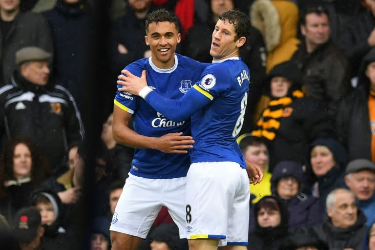 Everton's striker Dominic Calvert-Lewin (L) celebrates with midfielder Ross Barkley after scoring the opening goal of the English Premier League football match against Hull City March 18, 2017