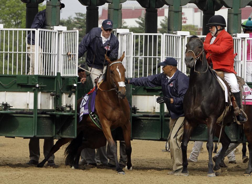 Empress Of Midway is helped out of the starting gate before the start the 140th running of the Kentucky Oaks horse race at Churchill Downs Friday, May 2, 2014, in Louisville, Ky. (AP Photo/Garry Jones)