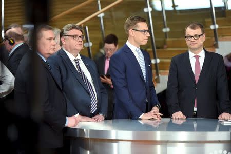 The Social Democrats' chairman Antti Rinne (front L-R), the Finns Party's chairman Timo Soini, chairman Alexander Stubb of the National Coalition and chairman Juha Sipila of the Centre Party are seen at a news conference for the Finnish parliamentary elections at the annex of parliament, Little Parliament building in Helsinki April 19, 2015. REUTERS/Jussi Nukari/Lehtikuva