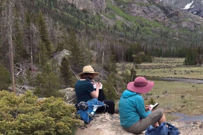 A group of women travelers looks over a river on a hiking trip in the Colorado Rockies in 2023. Photo courtesy of Adventures in Good Company