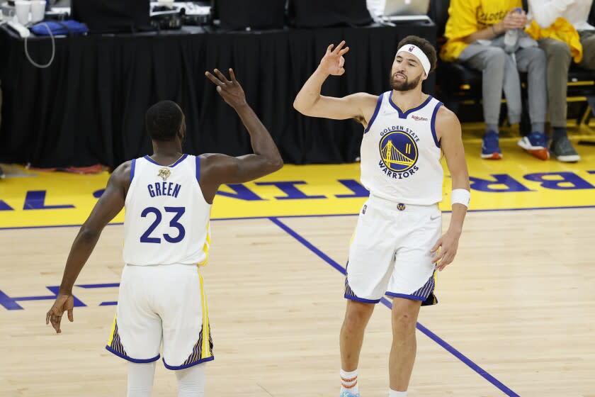 Golden State Warriors guard Klay Thompson (11) celebrates with forward Draymond Green (23) during the second half of Game 1 of basketball's NBA Finals against the Boston Celtics in San Francisco, Sunday, June 5, 2022. (AP Photo/John Hefti)