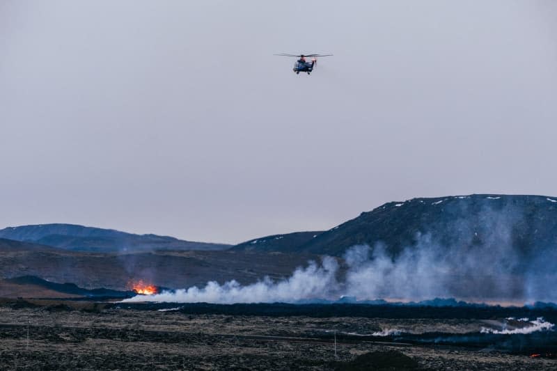 A helicopter monitors the evolution of the volcanic lava from above. Since the volcanic eruption began on 14 January, the eruption's intensity has been decreasing, although some houses were hit by lava. Raul Moreno/SOPA Images via ZUMA Press Wire/dpa