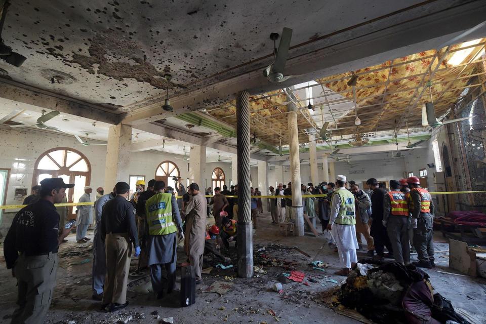 Security officials examine the site of the blast (AFP via Getty Images)