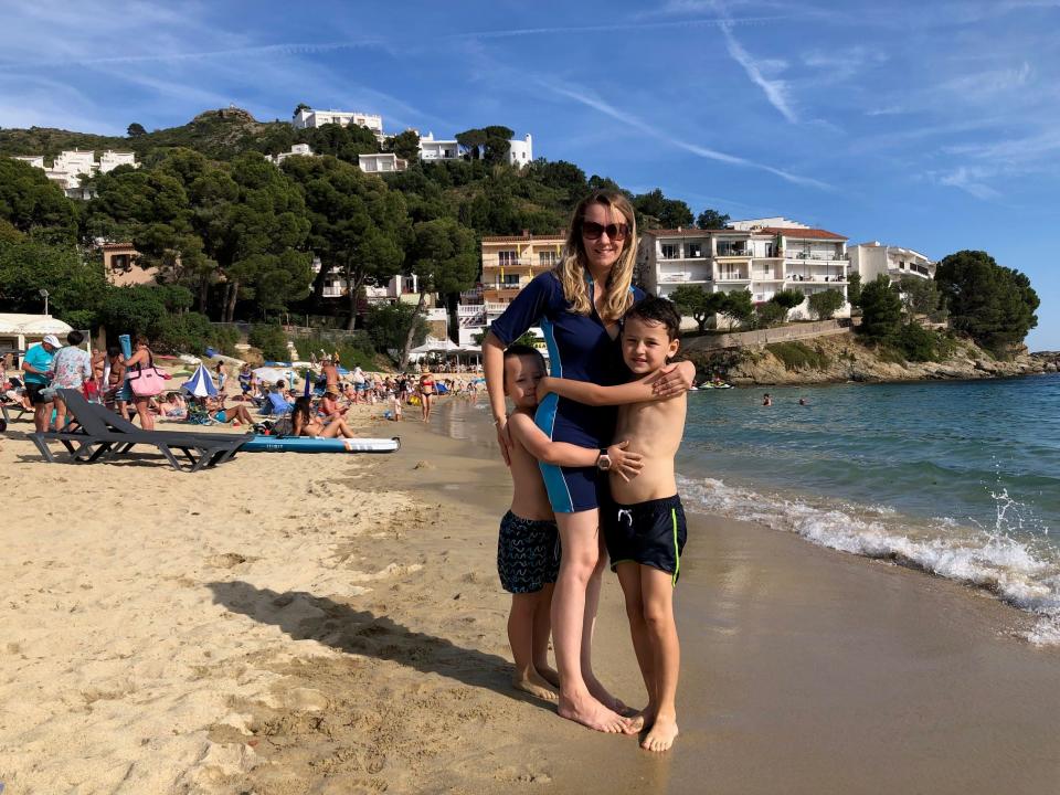 Woman on beach with two children in Spain