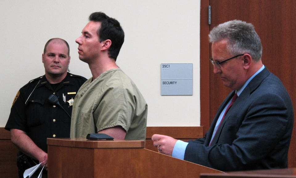 FILE - In this June 5, 2019 file photo former critical care doctor William Husel, center, pleads not guilty to murder charges while appearing with defense attorney Richard Blake, right, in Franklin County Court in Columbus, Ohio. An Ohio hospital system has reached nearly $4.5 million in settlements so far over the deaths of patients who allegedly received excessive painkiller doses ordered by Husel, now charged with murder. Over two dozen wrongful-death lawsuits have been filed against the Columbus-area Mount Carmel Health System and now-fired intensive care doctor William Husel. (AP Photo/Kantele Franko)
