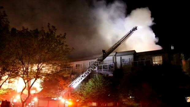 Firefighters in Surrey, B.C., battled for hours against a fire at a four-storey building in the Fleetwood neighbourhood that displaced dozens of households.  (Shane MacKichan - image credit)