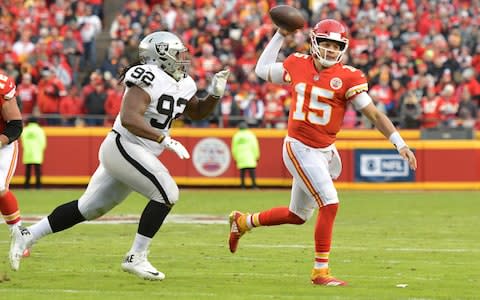 Kansas City Chiefs quarterback Patrick Mahomes (15) throws a pass against Oakland Raiders defensive tackle P.J. Hall (92) during the first half at Arrowhead Stadium - Credit: USA TODAY