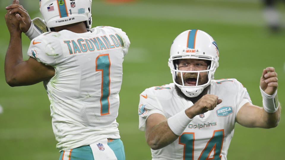 LAS VEGAS, NEVADA - DECEMBER 26: Ryan Fitzpatrick #14 of the Miami Dolphins celebrates his touchdown pass with Tua Tagovailoa #1, to take a 23-22 lead over the Las Vegas Raiders, during the fourth quarter at Allegiant Stadium on December 26, 2020 in Las Vegas, Nevada. (Photo by Harry How/Getty Images)