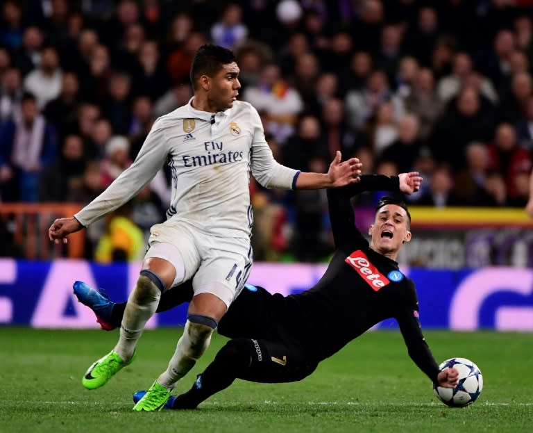 Real Madrid's midfielder Casemiro (L) vies with Napoli's midfielder Jose Maria Callejon during the UEFA Champions League round of 16 first leg football match February 15, 2017