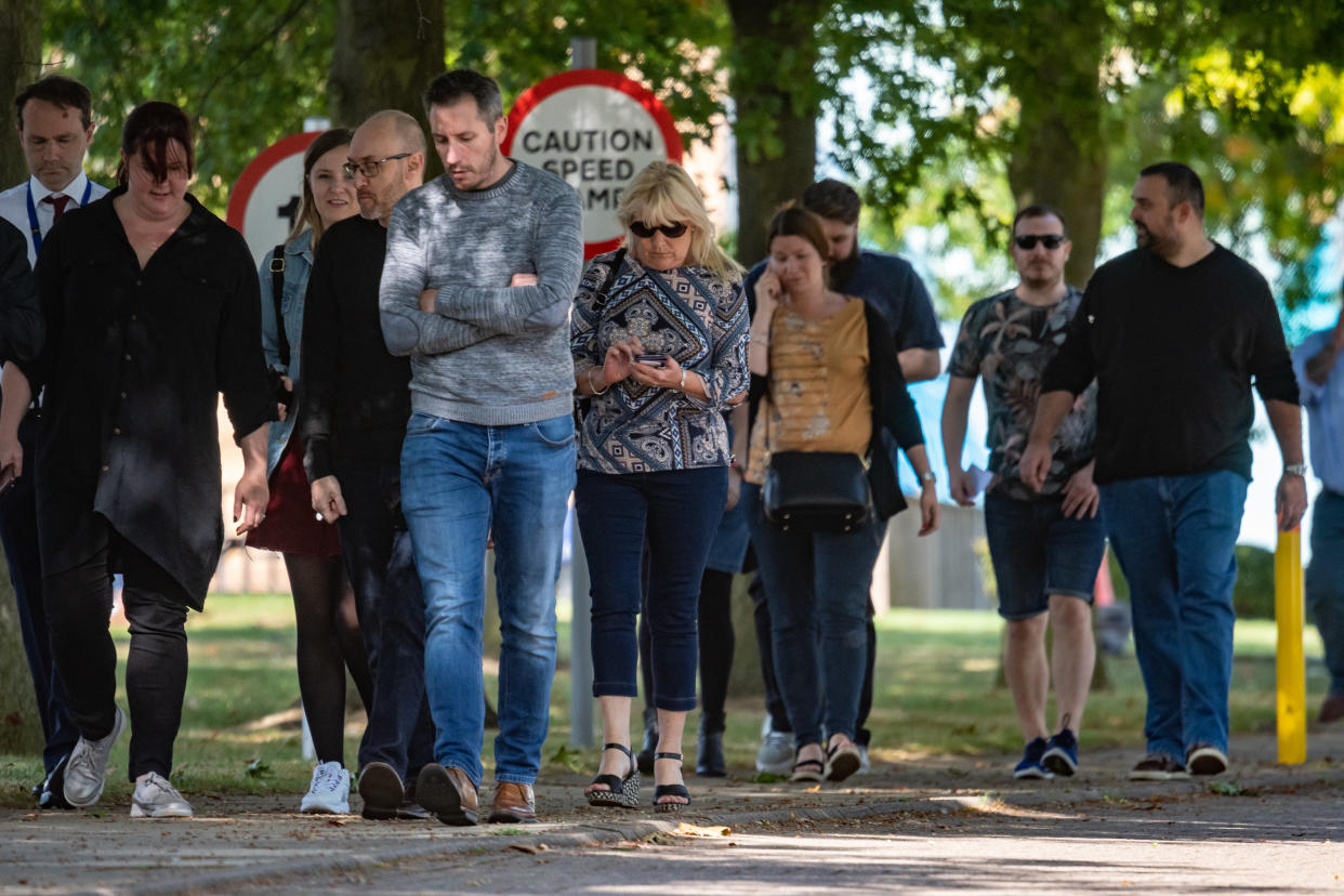 Devastated staff left Thomas Cook's head office on Monday. Photo: SWNS