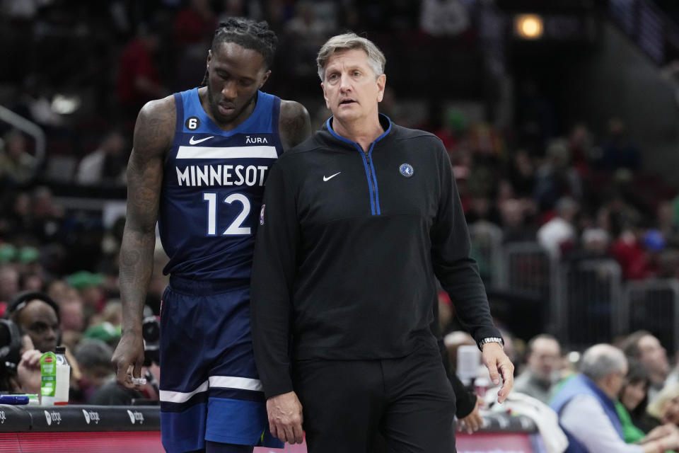 Minnesota Timberwolves coach Chris Finch, right, talks with forward Taurean Prince during the first half of the team's NBA basketball game against the Chicago Bulls in Chicago, Friday, March 17, 2023. (AP Photo/Nam Y. Huh)