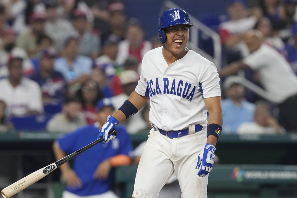 Nicaragua's Orlando Valle (19) grimaces after a pitch during the fifth inning of a World Baseball Classic game against the Dominican Republic, Monday, March 13, 2023, in Miami. (AP Photo/Marta Lavandier)