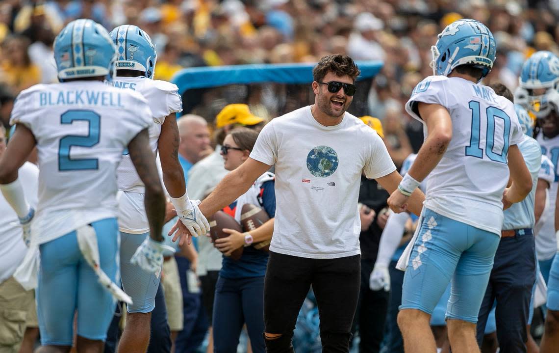 Former North Carolina quarterback Sam Howell greets North Carolina quarterback Drake Maye (10) and the offensive unit after scoring their first touchdown against Appalachian State on Saturday, September 3, 2022 at Kidd Brewer Stadium in Boone, N.C. Robert Willett/rwillett@newsobserver.com