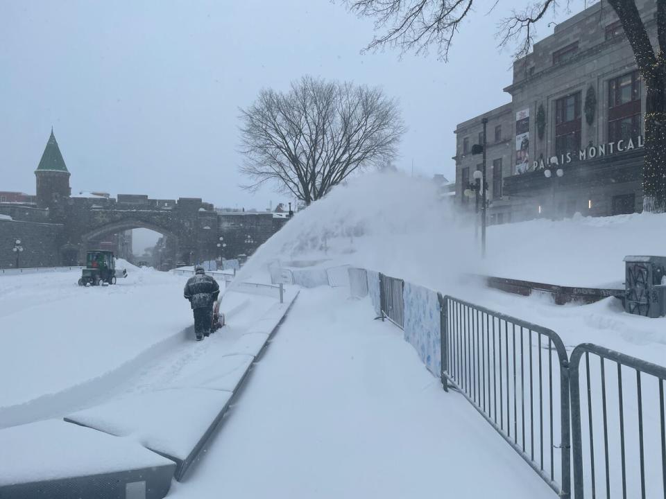 A city worker clears the 21 centimetres of snow that fell on the outdoor skating rink at Place D'Youville in Quebec City. 