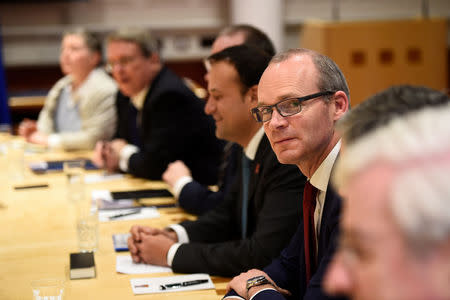 Deputy Prime Minister (Tanaiste) Simon Coveney sits at a meeting table at Government buildings in Dublin, Ireland, December 1, 2017. REUTERS/Clodagh Kilcoyne