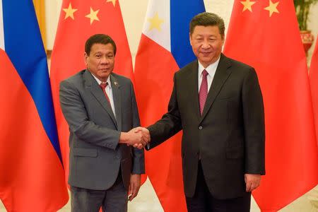 Chinese President Xi Jinping (R) shakes hands with Philippines President Rodrigo Duterte prior to their bilateral meeting during the Belt and Road Forum, at the Great Hall of the People in Beijing, China May 15, 2017. REUTERS/Etienne Oliveau/Pool