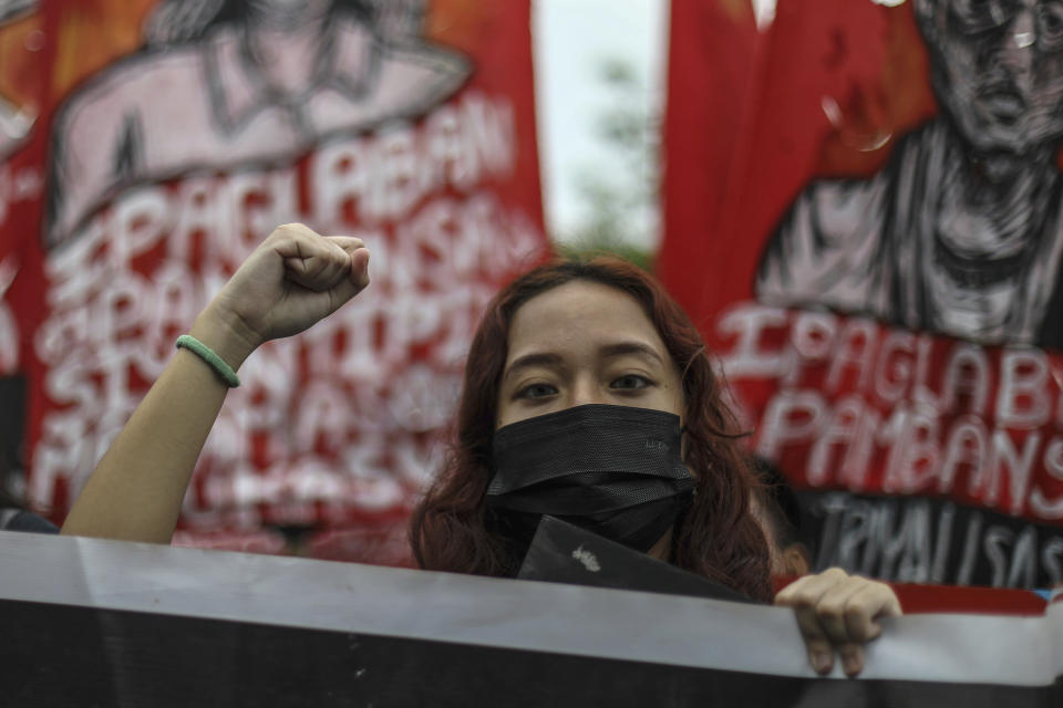 An activist raises a clenched fist during a protest in Quezon City, Phillippines, on Monday, July 24, 2023, ahead of the second State of the Nation Address of Philippine President Ferdinand Marcos Jr. (AP Photo/Gerard Carreon)