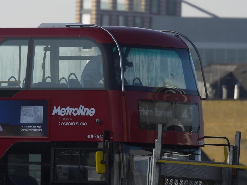 A forensic offices investigates what appears to be a bullet hole in the front window of the bus on London Bridge: Peter Summers/Getty Images