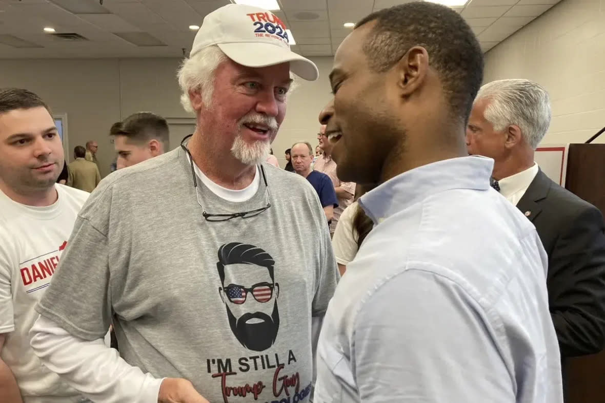 Republican gubernatorial candidate Daniel Cameron, right, chats after a campaign rally on Wednesday, April 12, 2023, in suburban Louisville, Ky. (AP Photo/Bruce Schreiner)