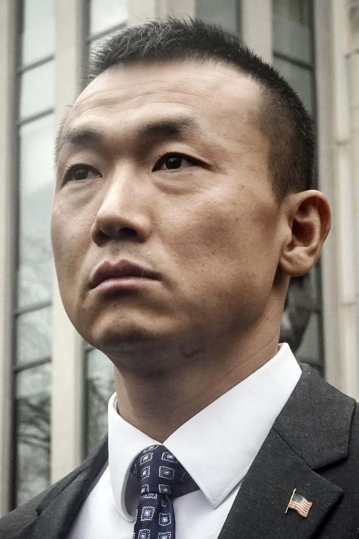 NYPD officer Baimadajie Angwang, a naturalized U.S. citizen born in Tibet, listens during a press briefing outside Brooklyn's Federal court after a judge dismissed spy charges against him, Thursday Jan. 19, 2023, in New York. Federal prosecutors dropped charges against Angwang, who authorities had initially accused of spying on independence-minded Tibetans on behalf of the Chinese consulate in New York. (AP Photo/Bebeto Matthews)