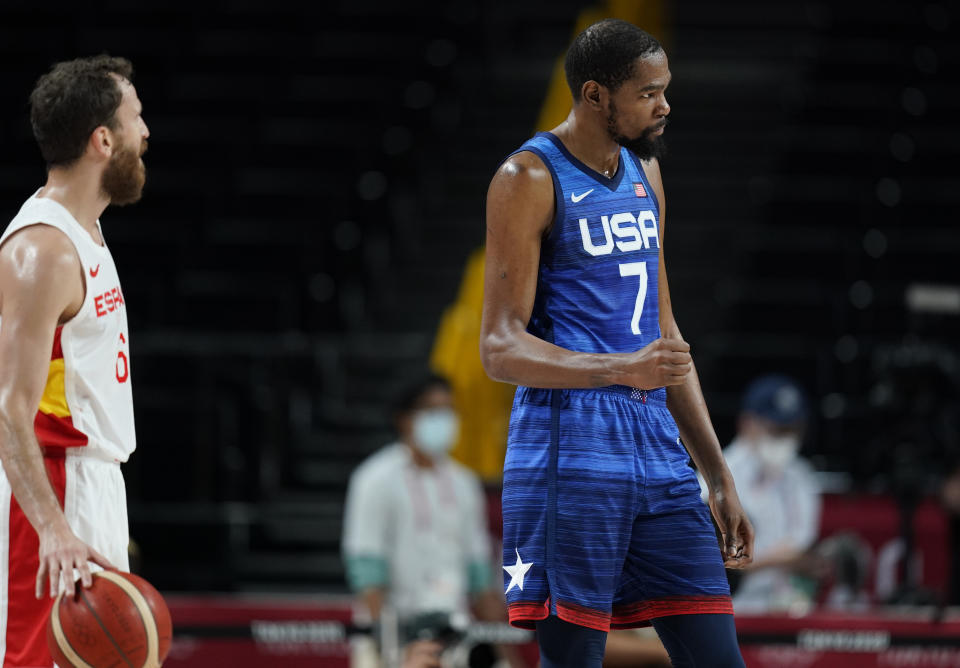 United States' Kevin Durant (7), right, reacts to celebrate their win in the men's basketball quarterfinal game against Spain at the 2020 Summer Olympics, Tuesday, Aug. 3, 2021, in Saitama, Japan. (AP Photo/Charlie Neibergall)