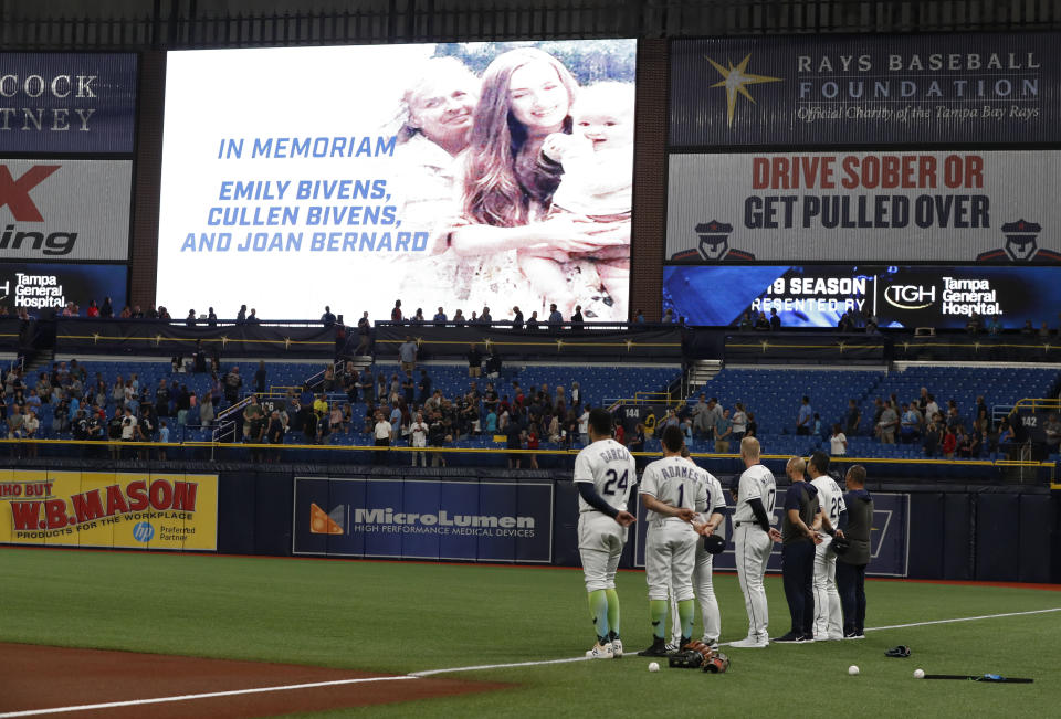 Before a baseball game against the Cleveland Indians, Tampa Bay Rays players stand for a moment of silence in support of Montgomery Biscuit player Blake Bivens whose family was recently murdered, Friday, Aug. 30, 2019, in St. Petersburg, Fla. (AP Photo/Scott Audette)