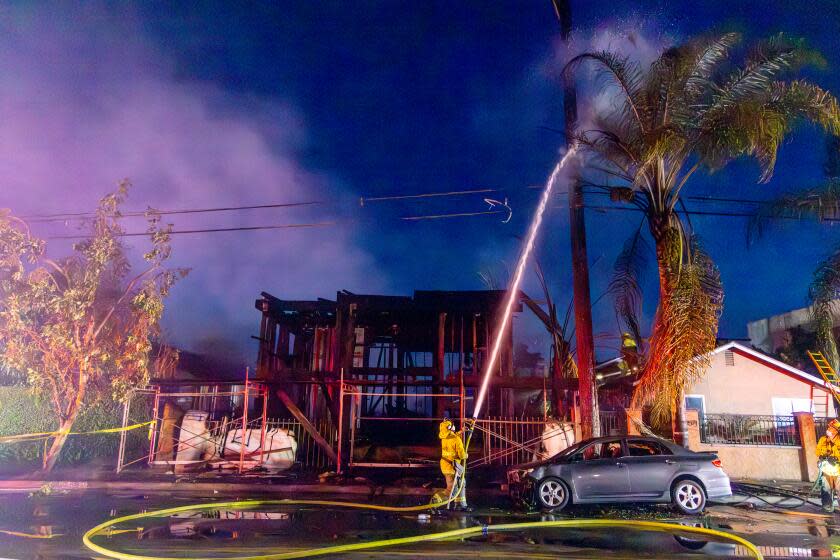 SOUTH LOS ANGELES, CA - NOVEMBER 28: Firefighters fight a massive fire at an apartment building in the framing stages of construction caused evacuations of nearby residents at 1585 E. Vernon St. on Tuesday, Nov. 28, 2023 in South Los Angeles, CA. (Irfan Khan / Los Angeles Times)