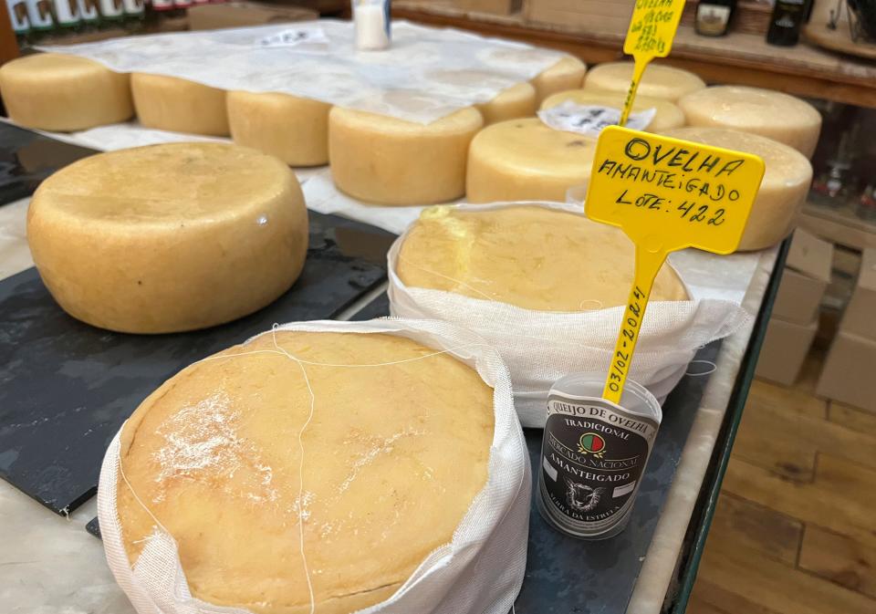 Wheels of traditional sheep cheese from the Serra da Estrela region of Portugal are shown for sale at the Mercado Nacional tavern in Belmonte, Portugal on Sept. 17, 2023. (Kristen de Groot via AP)