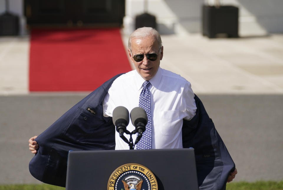 President Joe Biden removes his jacket as he speaks about the Inflation Reduction Act of 2022, during a ceremony on the South Lawn of the White House in Washington, Tuesday, Sept. 13, 2022. (AP Photo/Andrew Harnik)