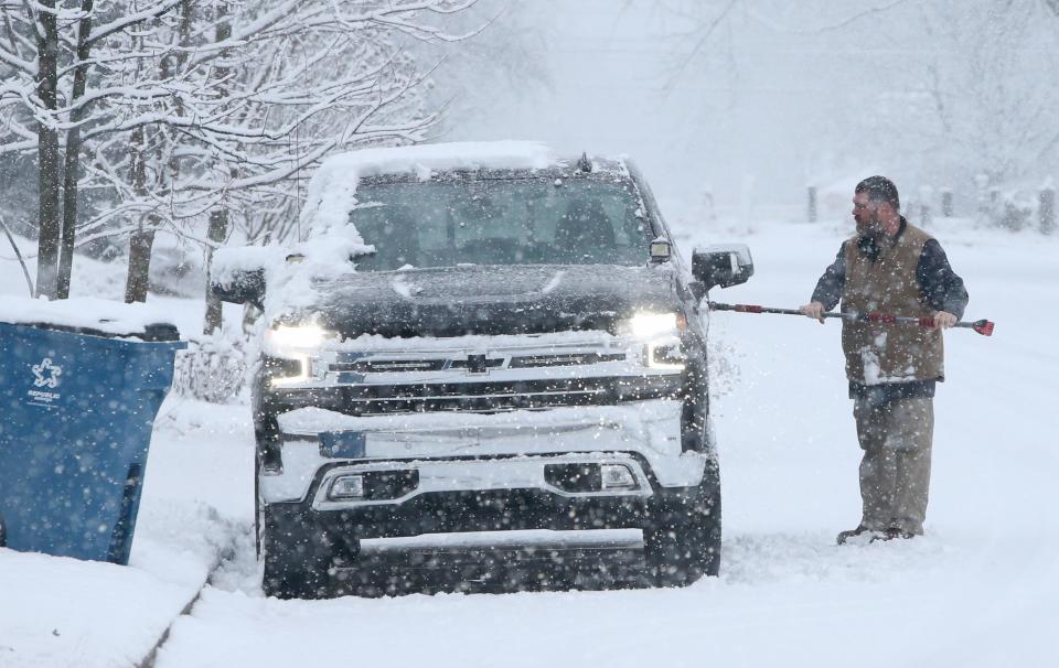 A homeowner clears snow from his truck Wednesday, Jan. 25, 2023, in Mishawaka during the recent snowfall.