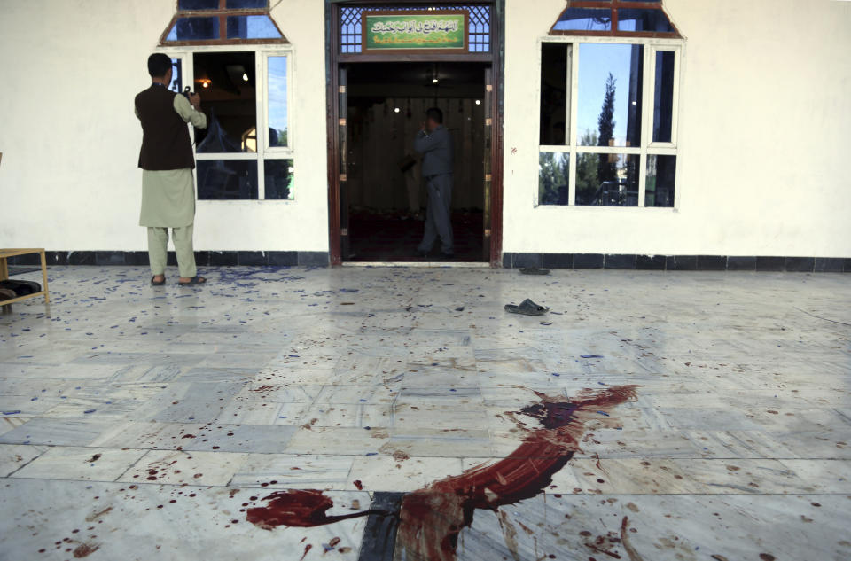 An Afghan security personnel stands inside a mosque after a bomb explosion during Friday prayer on the outskirts of Kabul, Afghanistan, Friday, May 24, 2019. According to Kabul police chief's spokesman, Basir Mujahid, the bomb was concealed in the microphone used to deliver the sermon. The prayer leader, Maulvi Samiullah Rayan, was the intended target, the spokesman added. (AP Photo/Rahmat Gul)