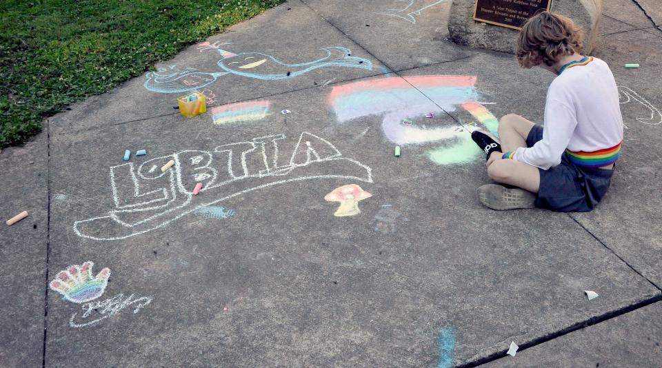 Children and teenagers chalked the nearby sidewalk with LGBTQA artwork.
