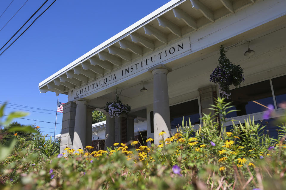 Flowers bloom outside the Chautauqua Institution welcome center in Chautauqua, N.Y., Friday, Aug. 12, 2022. Salman Rushdie, the author whose writing led to death threats from Iran in the 1980s, was attacked and apparently stabbed in the neck Friday by a man who rushed the stage as he was about to give a lecture at the Chautauqua Institution. (AP Photo/Joshua Bessex)