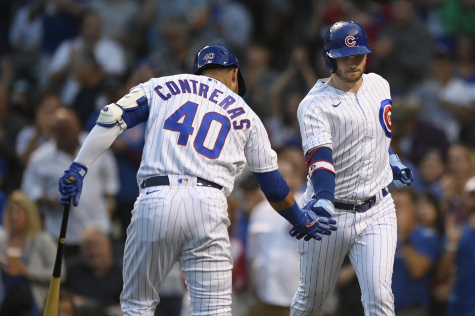 Chicago Cubs' Ian Happ ,right, celebrates with Willson Contreras (40) after hitting a solo home run during the first inning of the tema's baseball game against the Cincinnati Reds on Wednesday, Sept. 8, 2021, in Chicago. (AP Photo/Paul Beaty)