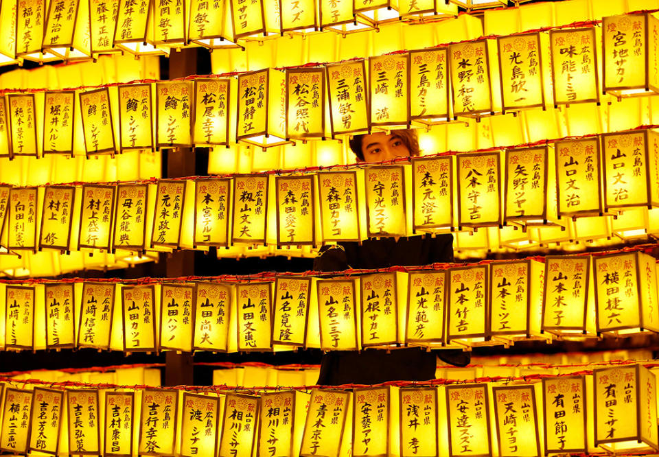 A man stands between thousands of paper lanterns during the Mitama Festival at Yasukuni Shrine in Tokyo