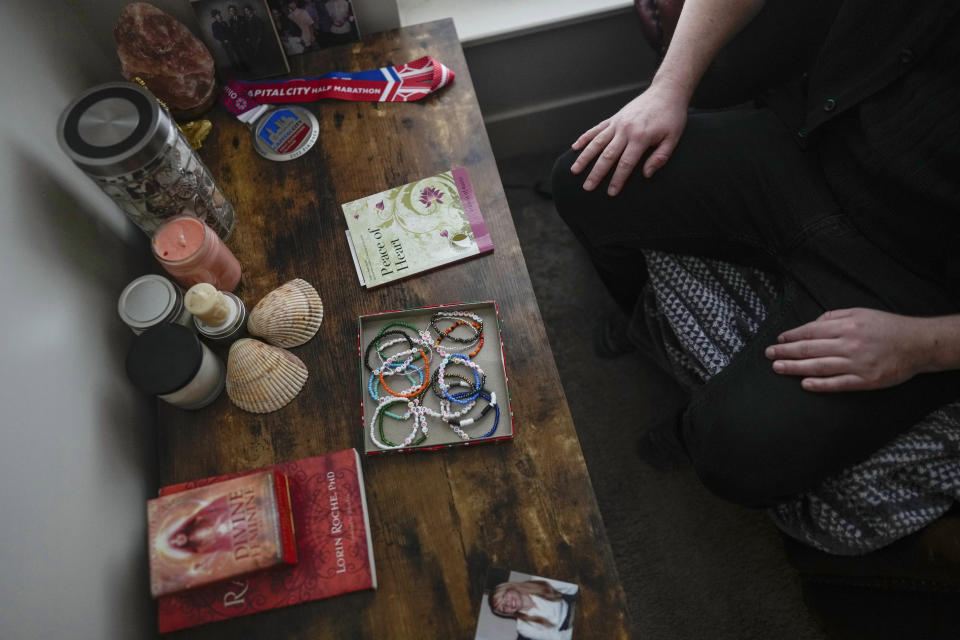 Ashton Colby's meditation corner has meaningful objects, including an image before he transitioned, in his apartment in Columbus, Ohio, on Thursday, Jan. 18, 2024. Ohio Gov. Mike DeWine announced proposals this month that transgender advocates say could block access to gender-affirming care provided by independent clinics and general practitioners, leaving thousands of adults scrambling for treatment and facing health risks. Colby, 31, fears the clinic where he gets the testosterone he has taken since age 19 would no longer offer it. (AP Photo/Carolyn Kaster)