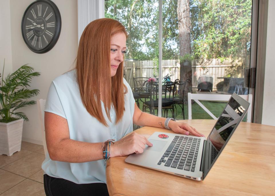 University of West Florida international student Zoraida Barrios Lopez, a native of Venezuela, works on her computer at home in Pensacola, Fla., on Friday. Under a now-abandoned ruling by the Trump administration, Lopez and other international students could have been forced to leave the country if their courses were fully online.