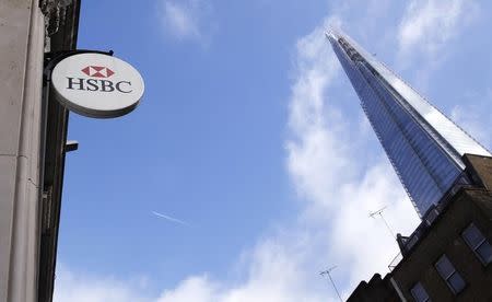 An HSBC sign is seen outside a bank branch near the Shard in London February 9, 2015. REUTERS/Suzanne Plunkett