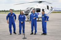 SpaceX Crew 2 astronauts, from left, European Space Agency astronaut Thomas Pesquet, NASA astronaut Megan McArthur, NASA astronaut Shane Kimbrough and Japan Aerospace Exploration Agency astronaut Akihiko Hoshide greet members of the media after they arrived at the Kennedy Space Center in Cape Canaveral, Fla., Friday, April 16, 2021. The launch to the International Space Station is targeted for April 22. (AP Photo/John Raoux)