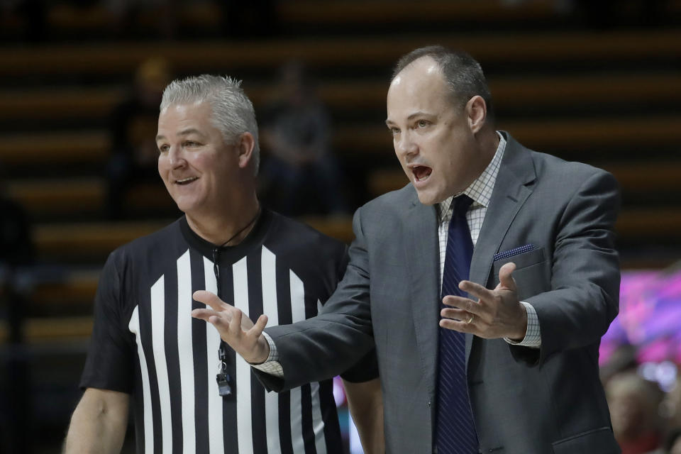 California coach Mark Fox, right, gestures next to an official during the first half of the team's NCAA college basketball game against Arizona State in Berkeley, Calif., Sunday, Feb. 16, 2020. (AP Photo/Jeff Chiu)