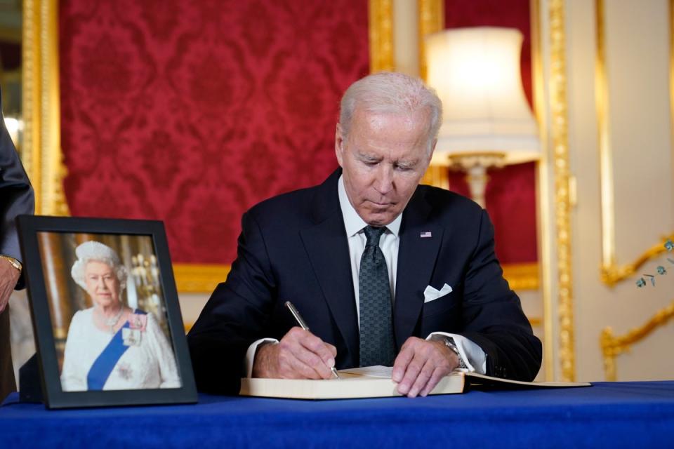 President Biden signs a book of condolence at Lancaster House in London (AP)