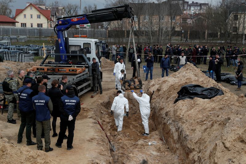 FILE PHOTO: Exhumation of bodies of civilians from a mass grave in Bucha