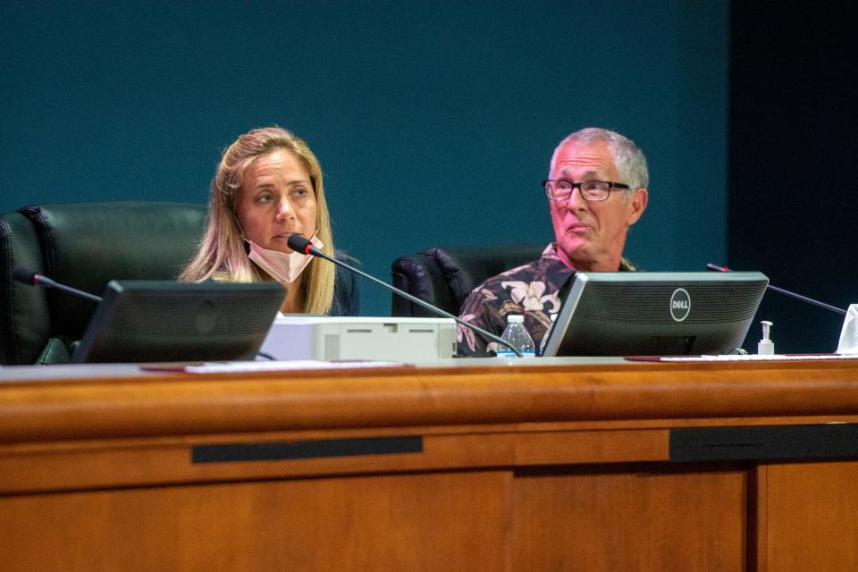 Escambia Children's Trust members Stephanie White and Rex Northrup listen during a meeting April 27 at the Escambia County Commission's chambers.