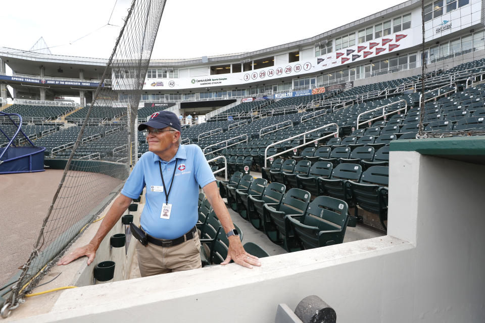 Hammond Stadium usher Ken Trammell looks out on an empty stadium, Thursday, March 12, 2020, in Fort Myers, Fla. Major League Baseball has suspended the rest of its spring training game schedule because if the coronavirus outbreak. MLB is also delaying the start of its regular season by at least two weeks. (AP Photo/Elise Amendola)