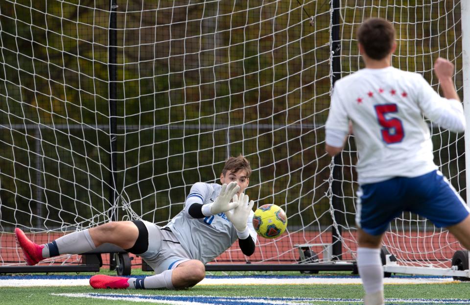 Holmdel goalkeeper Tommy Chyzowych makes a save during the penalty kick shootoutHolmdel Boys Soccer defeats Wall 1-0 on Penalty Kicks in Holmdel NJ. on November 4, 2021.