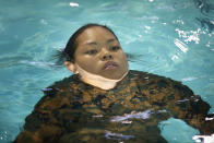 PARRIS ISLAND, SC - FEBRUARY 25: Marine recruit Joyce Venzon of Honolulu, Hawaii swims in her uniform while being tested to determine her swimming skills during boot camp February 25, 2013 at MCRD Parris Island, South Carolina. Male and female recruits are expected to meet the same standards during their swim qualification test. All female enlisted Marines and male Marines who were living east of the Mississippi River when they were recruited attend boot camp at Parris Island. About six percent of enlisted Marines are female. (Photo by Scott Olson/Getty Images)